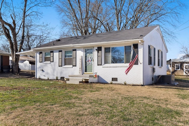 view of front of property with central air condition unit and a front yard