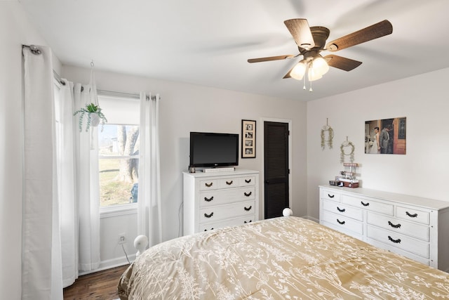 bedroom with ceiling fan and dark wood-type flooring