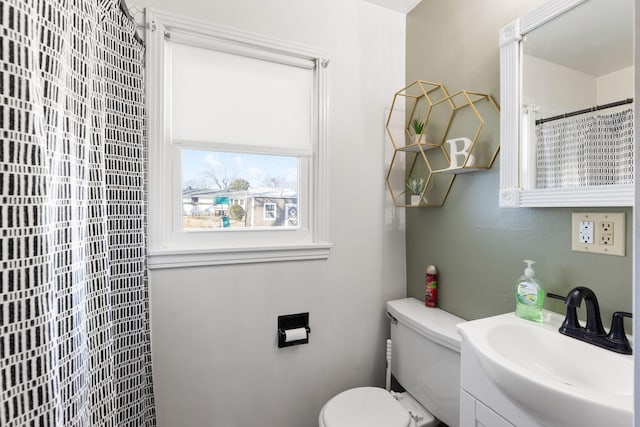 bathroom with vanity, toilet, and walk in shower