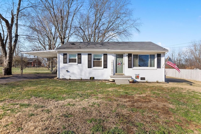 bungalow-style house featuring a front lawn and a carport