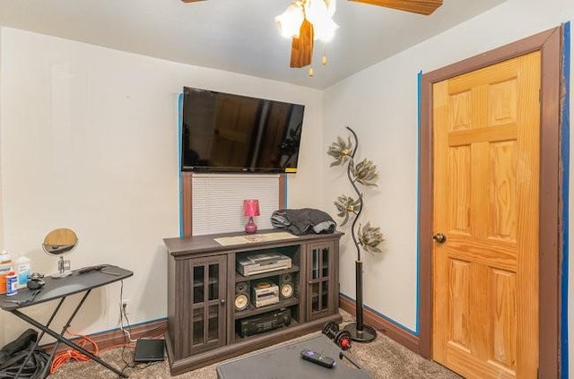 interior space featuring carpet flooring and ceiling fan