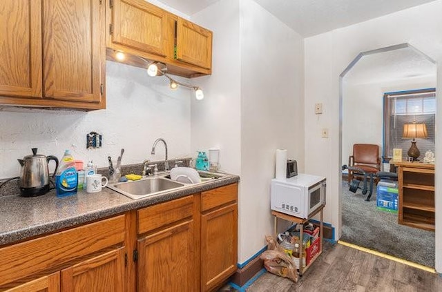 kitchen featuring dark hardwood / wood-style flooring and sink