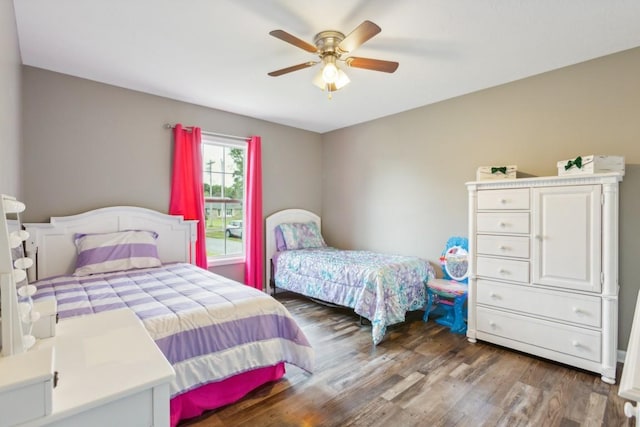 bedroom featuring ceiling fan and dark hardwood / wood-style floors