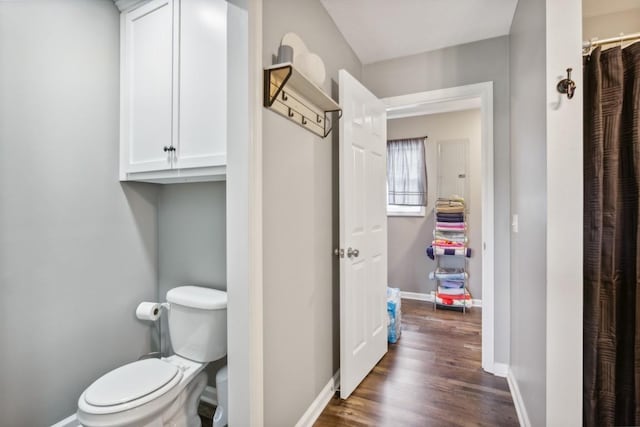 bathroom with hardwood / wood-style floors and toilet