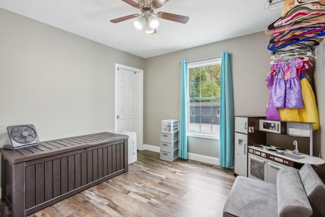 bedroom with ceiling fan and light hardwood / wood-style floors