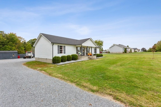 single story home with covered porch and a front yard