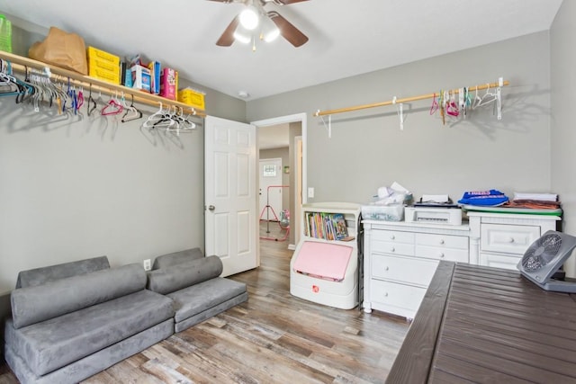 interior space with ceiling fan and wood-type flooring