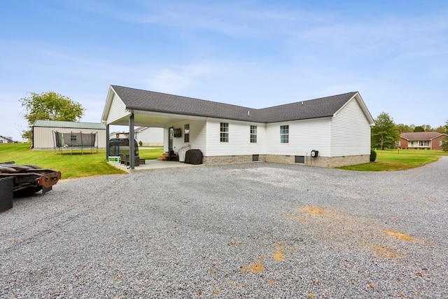 back of house with a yard and a carport