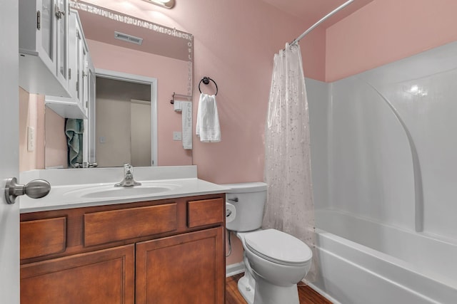 full bathroom with shower / tub combo with curtain, vanity, hardwood / wood-style floors, and toilet