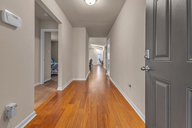 hall with light hardwood / wood-style floors