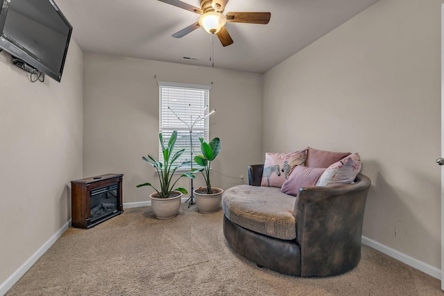 sitting room featuring carpet and ceiling fan