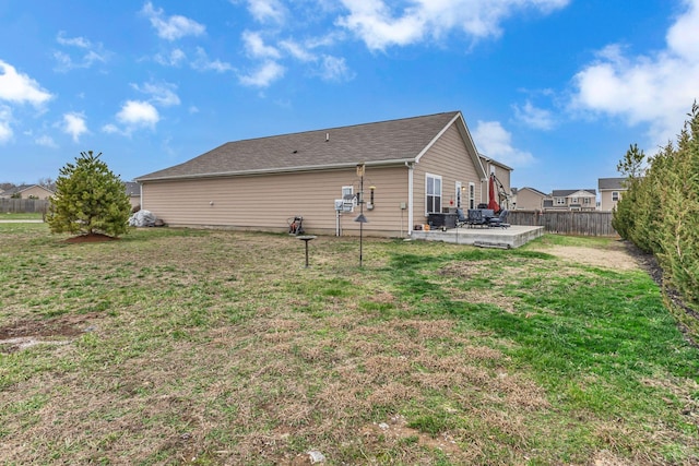 rear view of house featuring a patio area and a yard