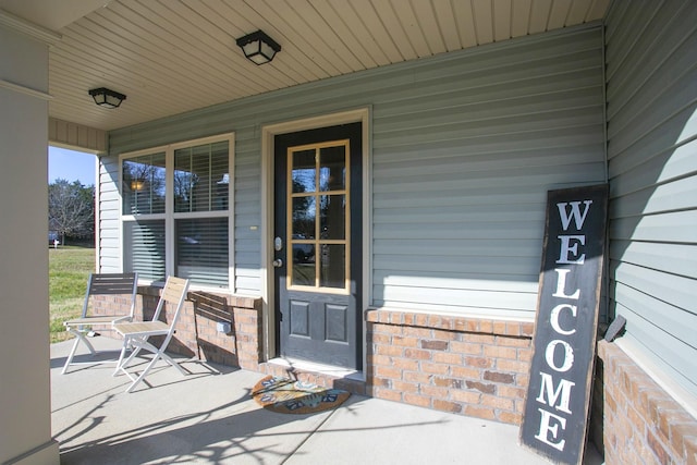 view of exterior entry with covered porch