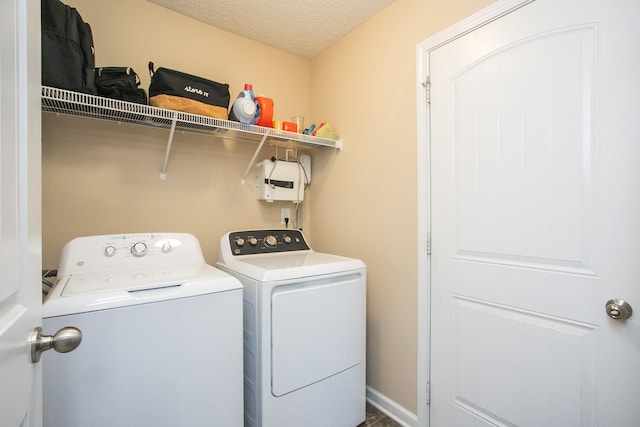 washroom with independent washer and dryer and a textured ceiling