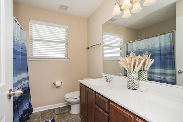 bathroom featuring an inviting chandelier, vanity, and toilet