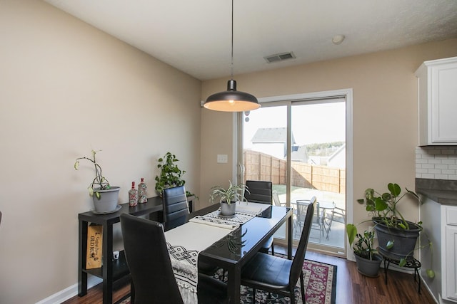 dining space with dark wood-type flooring