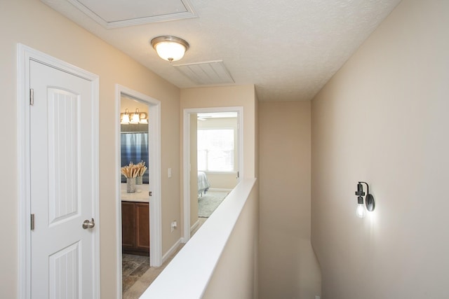 hallway with a textured ceiling