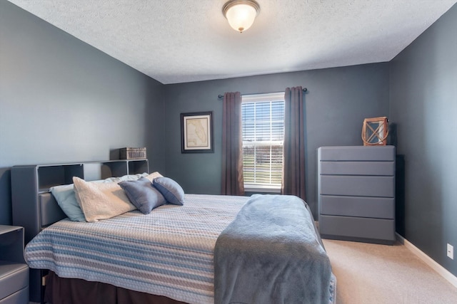 carpeted bedroom featuring a textured ceiling