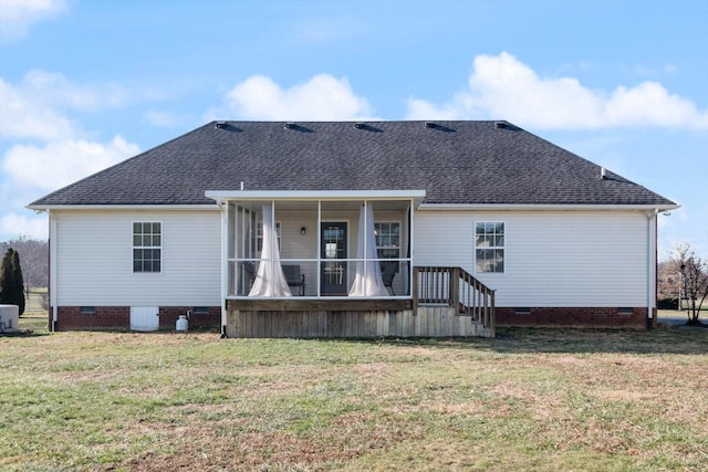 rear view of property featuring central air condition unit, a sunroom, and a lawn