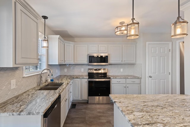 kitchen featuring white cabinets, stainless steel appliances, and pendant lighting