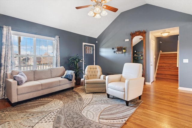 living room with lofted ceiling, hardwood / wood-style floors, and ceiling fan