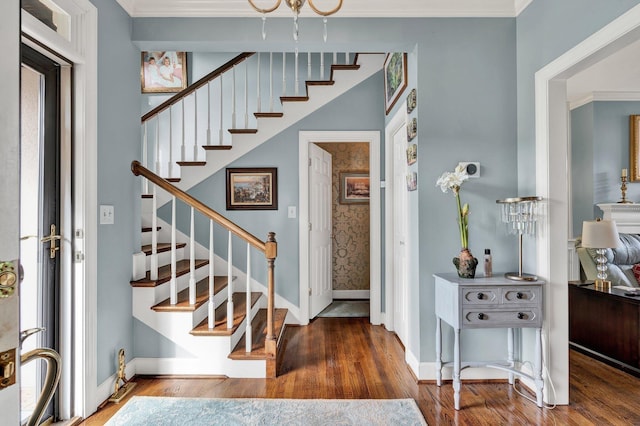 foyer entrance with crown molding, a wealth of natural light, and dark wood-type flooring