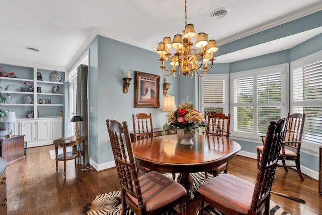 dining area featuring ornamental molding, built in features, dark wood-type flooring, and a chandelier