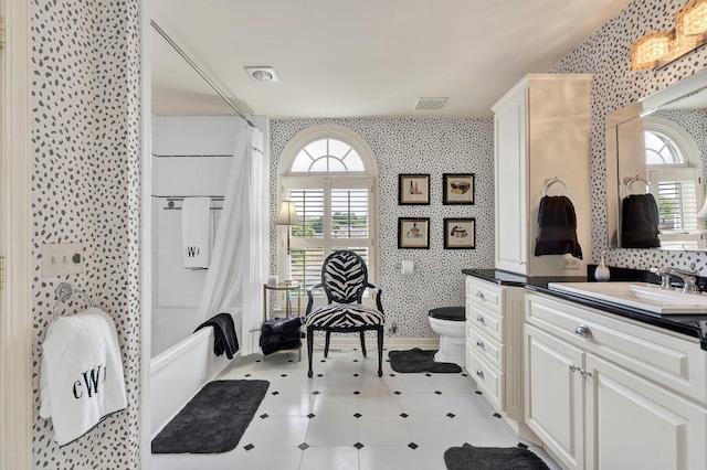 full bathroom featuring vanity, toilet, and shower / bath combo with shower curtain