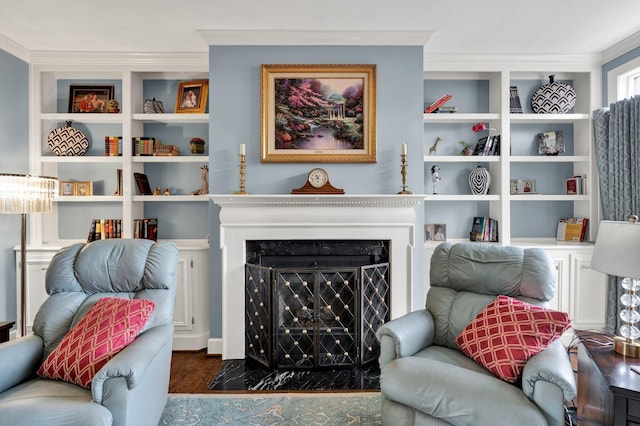 sitting room featuring dark hardwood / wood-style flooring, crown molding, and a premium fireplace