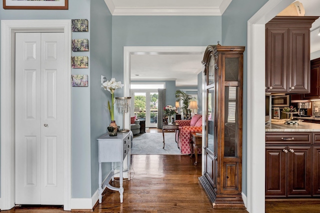 hall featuring dark hardwood / wood-style flooring, french doors, and ornamental molding