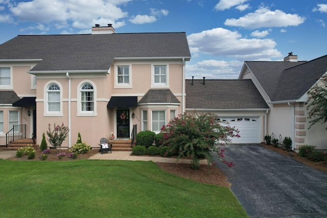 view of front of home with a garage and a front yard