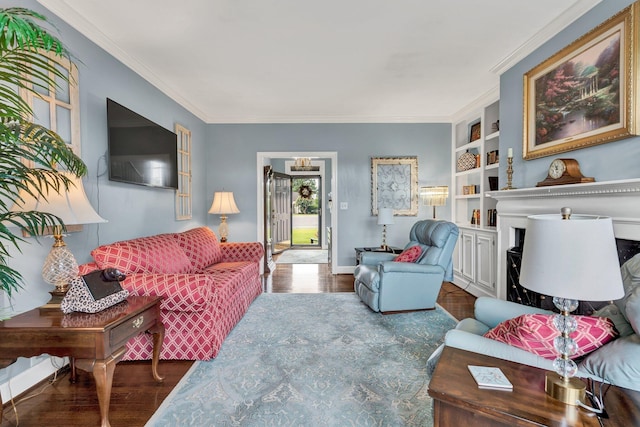 living room with a fireplace, built in features, ornamental molding, and dark wood-type flooring