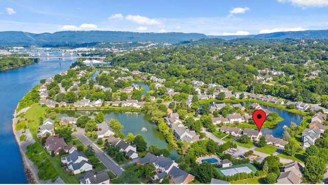 birds eye view of property with a water and mountain view