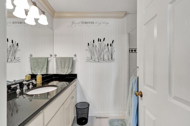 bathroom featuring tile patterned flooring, vanity, and ornamental molding