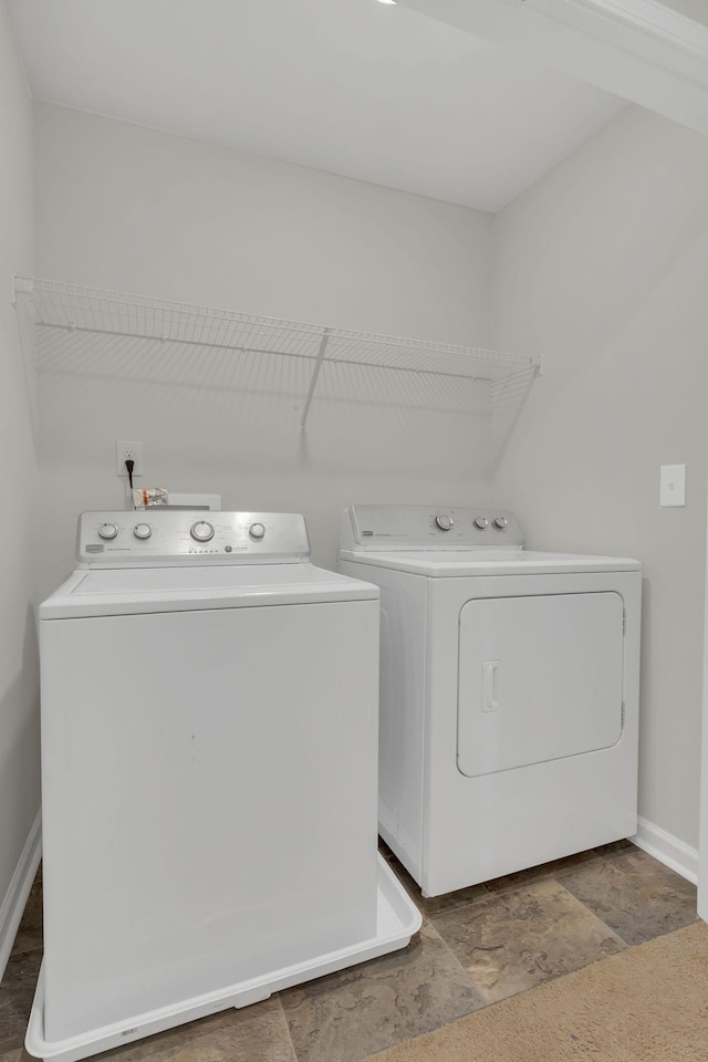 clothes washing area with washing machine and clothes dryer