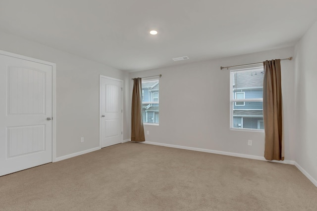 unfurnished room with light carpet