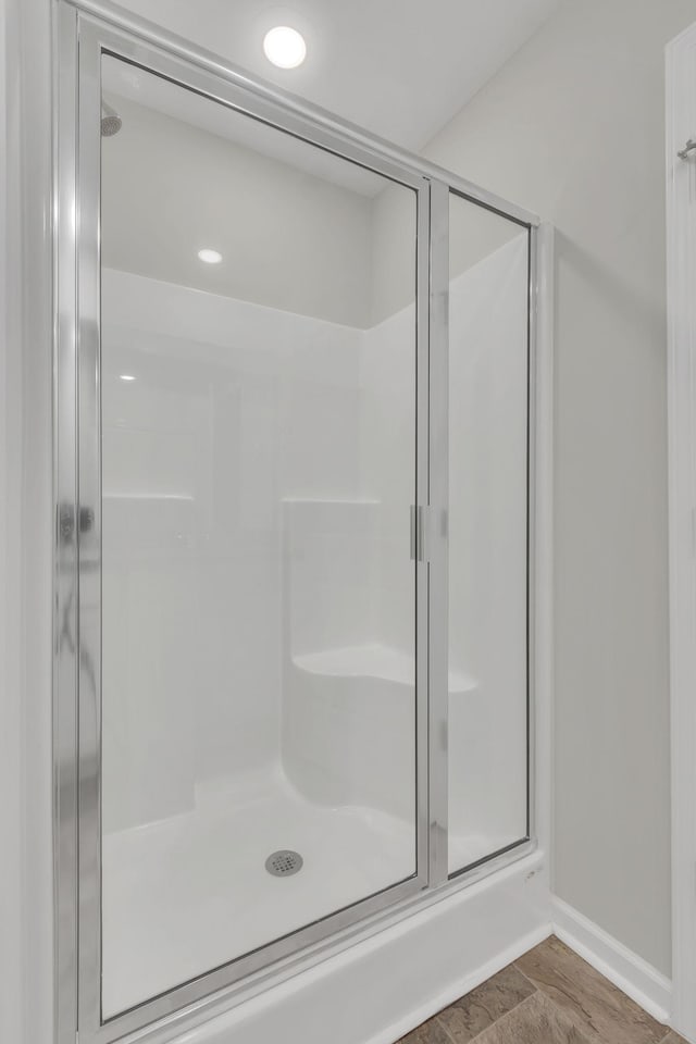 bathroom with a shower with shower door