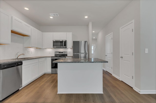 kitchen featuring white cabinetry, sink, a center island, and appliances with stainless steel finishes