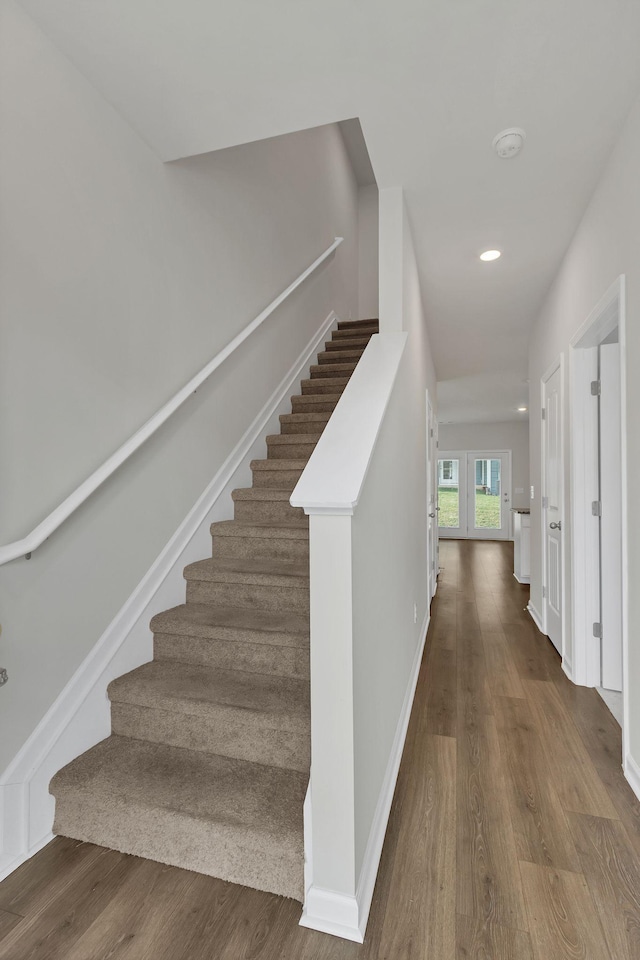 stairs with hardwood / wood-style flooring