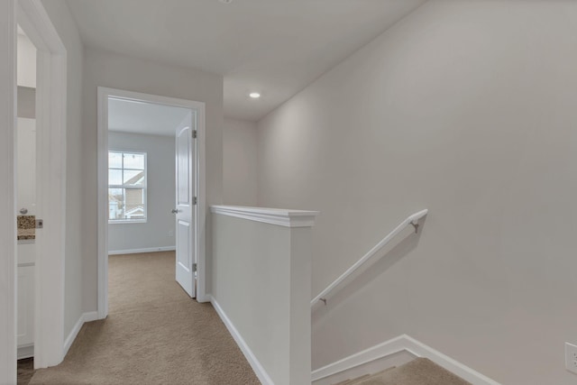 hallway with light colored carpet