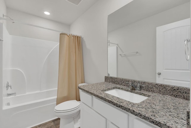 full bathroom featuring toilet, vanity, and shower / tub combo with curtain