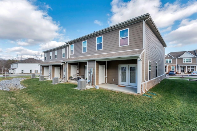 view of front of property with a patio area, a front lawn, and cooling unit