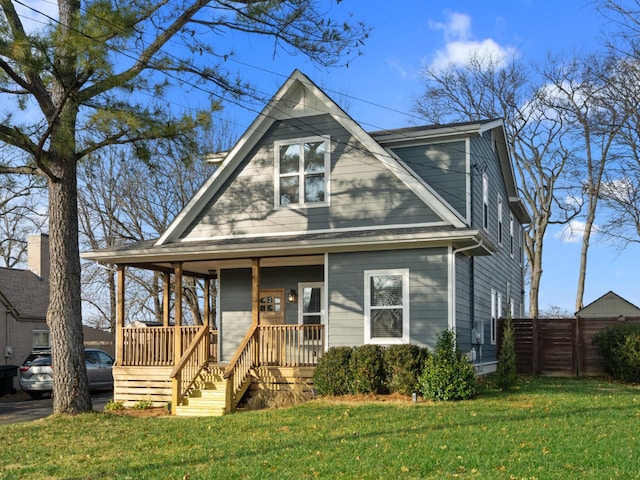 view of front of house featuring covered porch and a front lawn