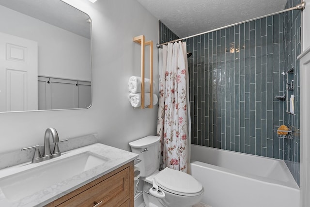 full bathroom featuring shower / tub combo with curtain, vanity, a textured ceiling, and toilet