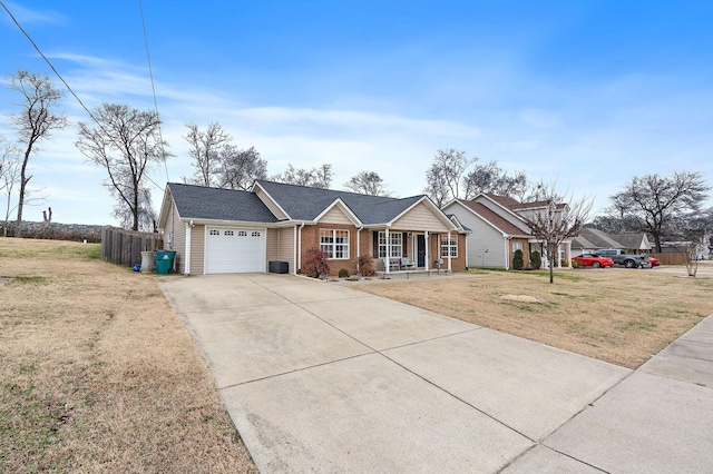 single story home featuring covered porch, a garage, and a front lawn