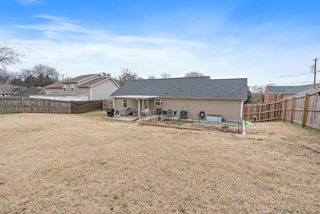 back of property featuring a lawn, a patio area, and central AC