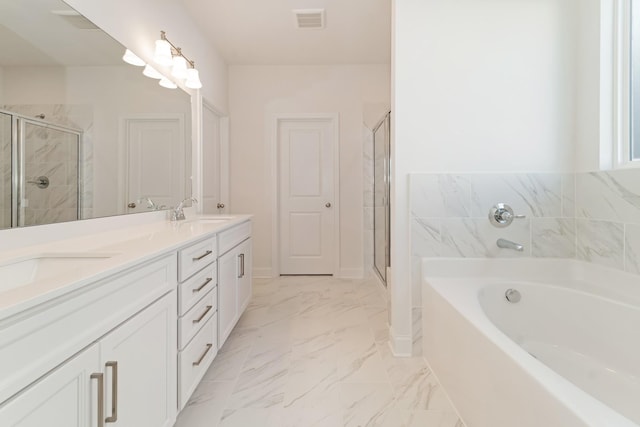 bathroom with vanity and shower with separate bathtub