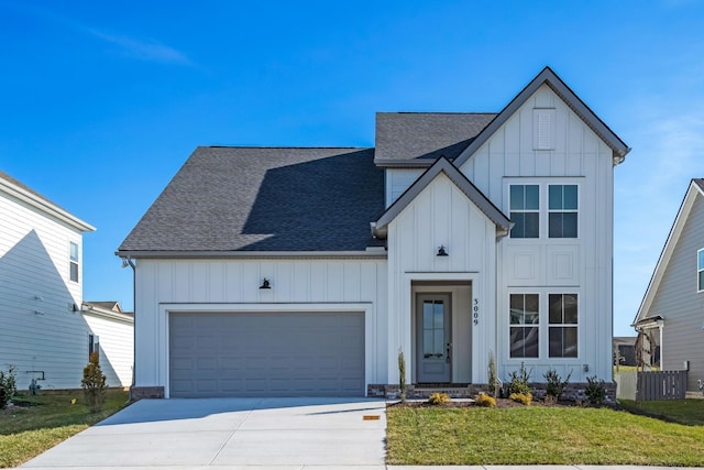 modern farmhouse featuring a front yard and a garage