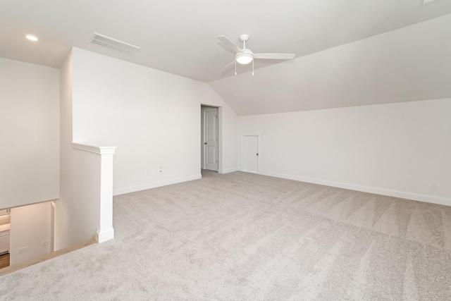 additional living space featuring light carpet, vaulted ceiling, and ceiling fan