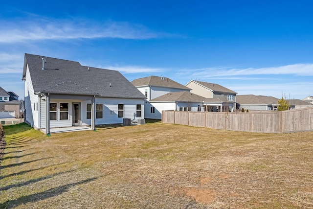 back of house featuring a patio area, a yard, and central air condition unit